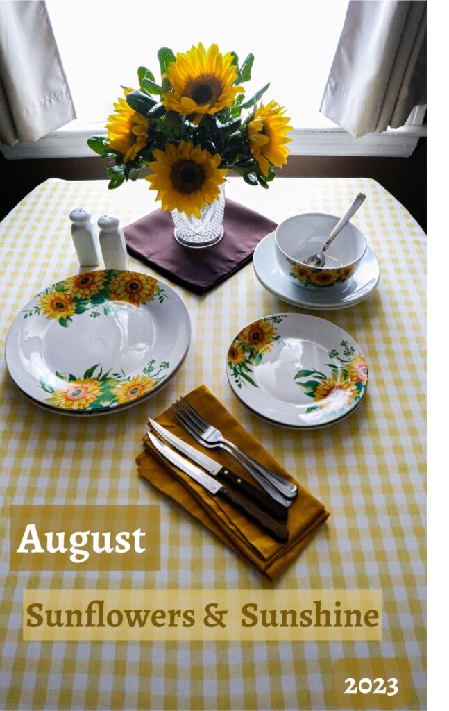 August table sunflowers and sunshine with sunflowers in a vase and design on the dishes on a yellow and white checkered tablecloth