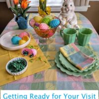 table set in easter theme getting party favors of plastic eggs filled with dinner mints tulips and bunny cookie jar on table