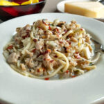 clam sauce over linguini with red pepper flakes served