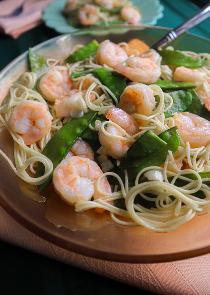 shrimp with pea pods served in an orange serving bowl