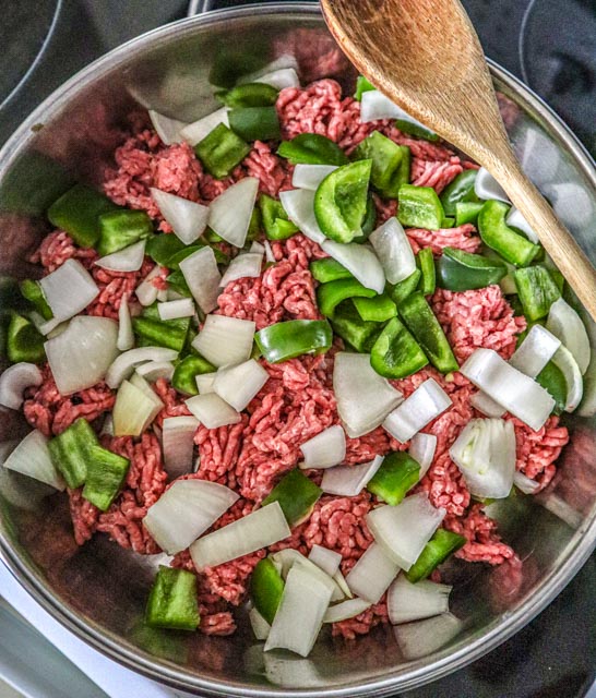 ground beef chopped green pepper and chopped onion in skillet