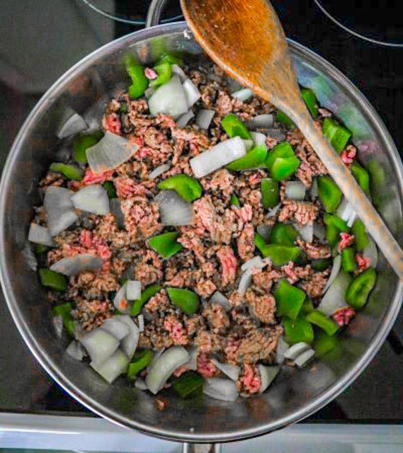 ground beef partially cooked with green pepper and onion
