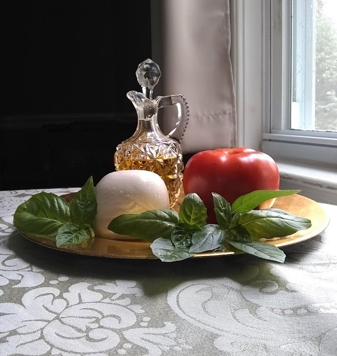 caprese salad ingredients tomato ball of mozzarella basil leaves on the stem olive oil