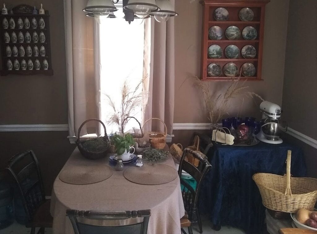 kitchen table from across the room a fall scene with baskets of herbs