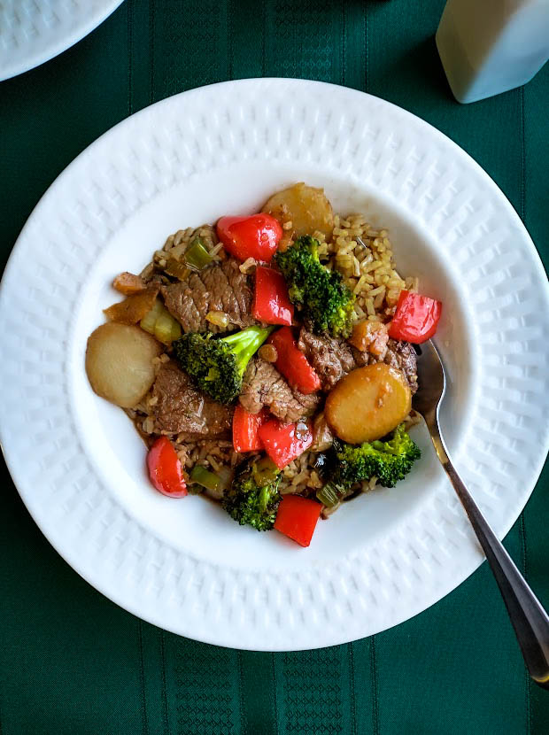 beef stir fry with asian flavor red pepper water chestnuts broccoli garlic and scallions with beef served over brown rice