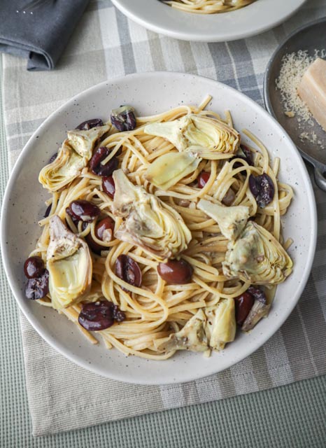 olive and artichoke pasta in a serving bowl