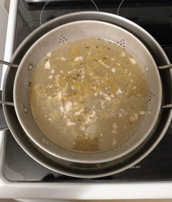 stock in pot with the colander