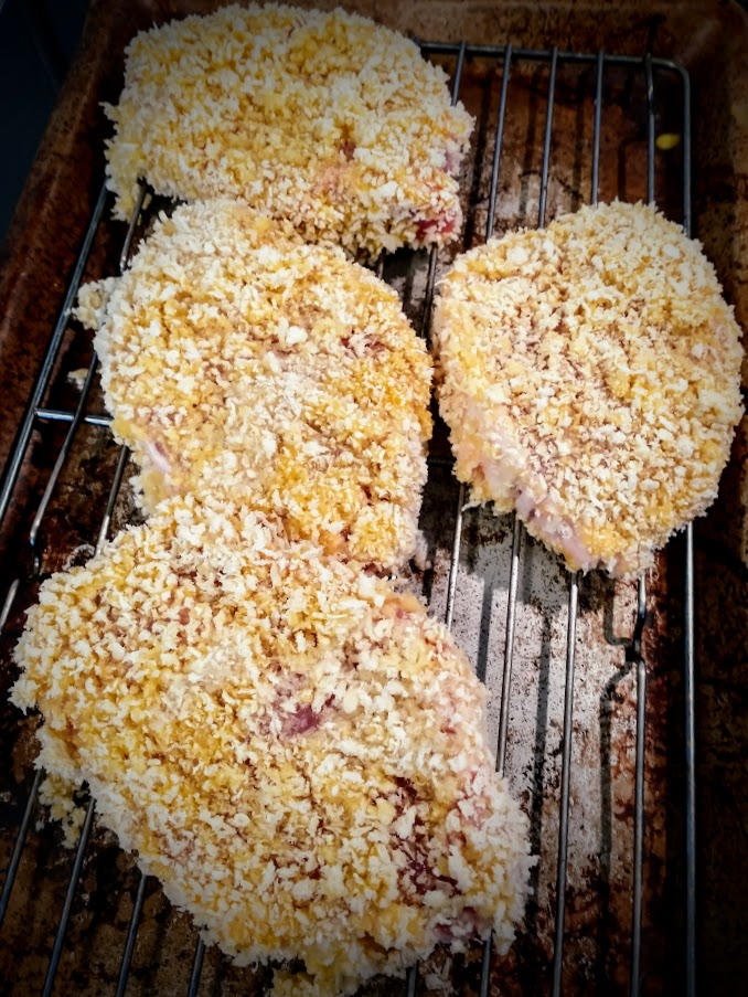 breaded pork cutlets on a baking rack