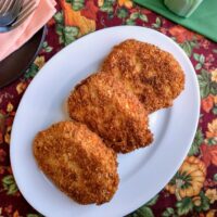 panko crusted pork cutlets on white serving platter