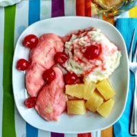 cherry chicken for finicky eaters served with a mashed potato sundae on a white plate on striped mat