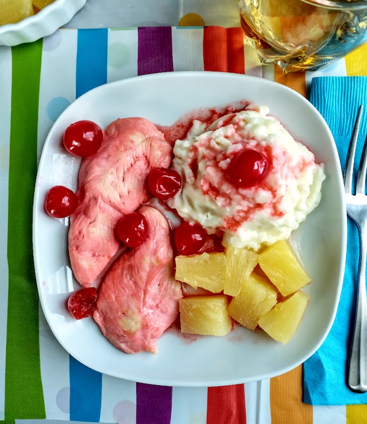 cherry chicken for finicky eaters served with a mashed potato sundae on a white plate on striped mat