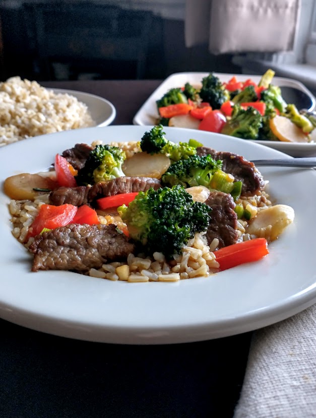 beef and vegetable stir fry with asian flavor beef broccoli red pepper water chestnuts scallions garlic beef  with ginger soy and soy sauce served over brown rice