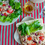 italian tuna salad in a sandwich and a salad with olive oil and mayo on the side