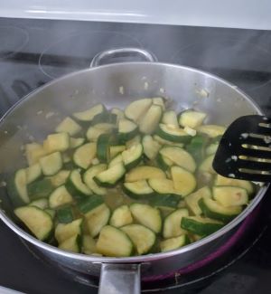 zucchini steaming in skillet