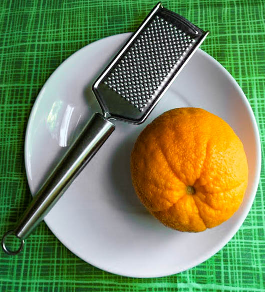 orange and grater used to zest the orange