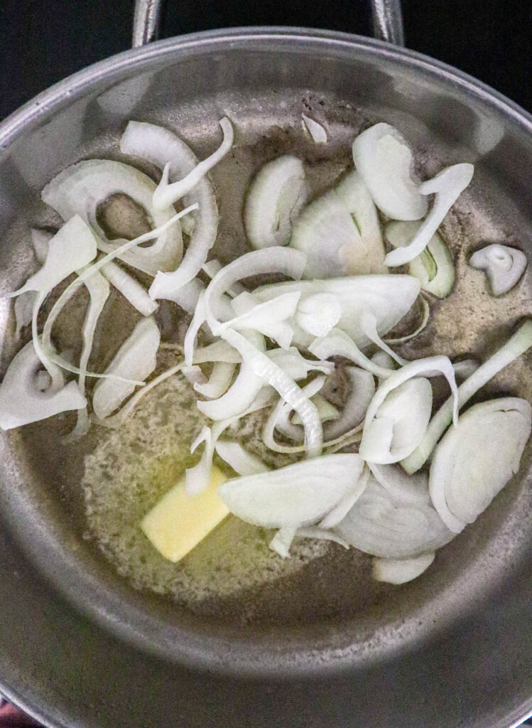 onions sauteing in skillet with butter for pork chops apples and onions