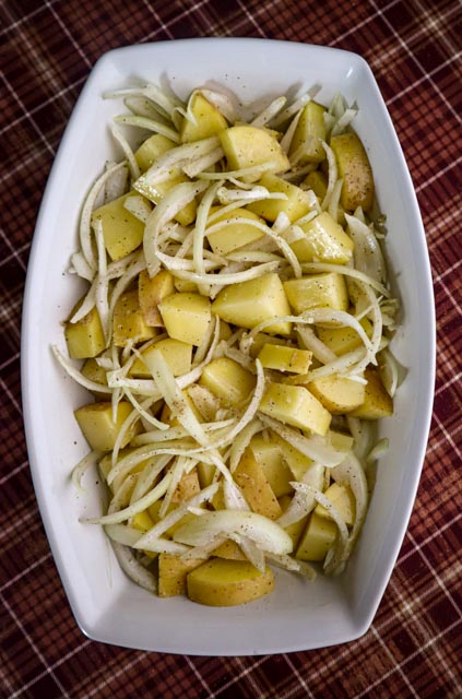 potatoes and onions are coated with the garlic butter sauce