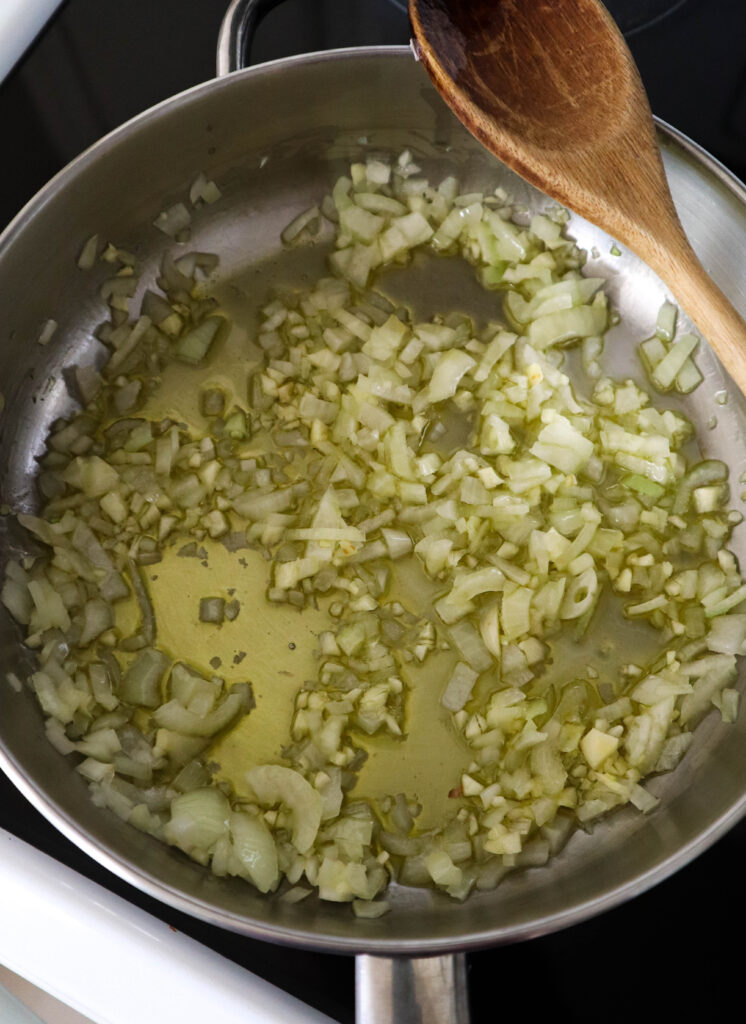 olive oil in skillet with chopped onion and garlic to saute