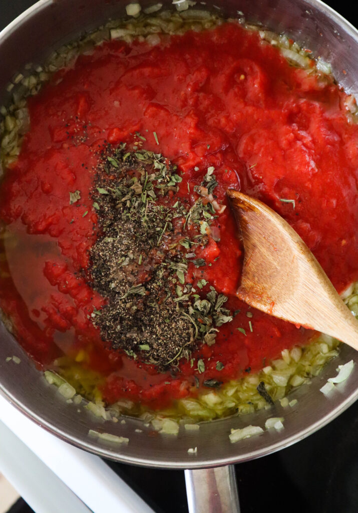 tomato herbs and spices added to the skillet