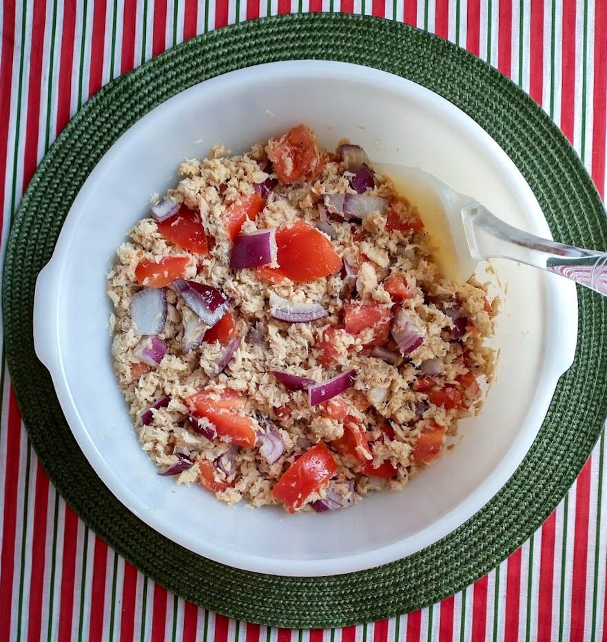 italian tuna salad ingredients all mixed in white bowl