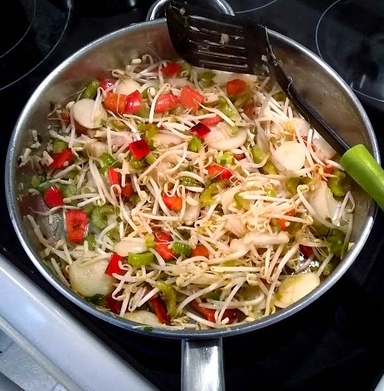 bean sprouts and water chestnuts added to skillet