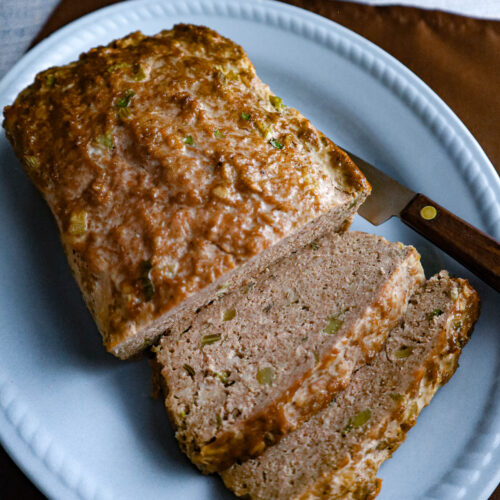 ground turkey meatloaf served on a light blue platter