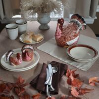 november dinner setting with turkey serving dishes with a theme all the leaves turn brown