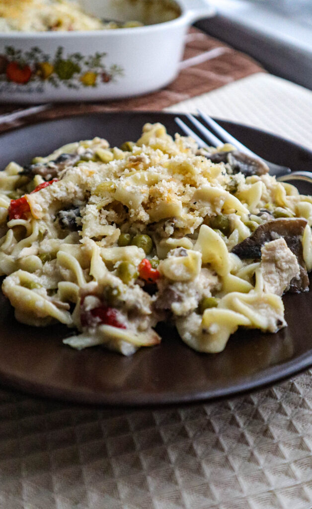 tuna noodle casserole spooned on to a single serving plate a view from the side