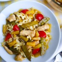 chicken pineapple stir fry served on a white plate