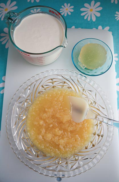 cream in measuring cup gelatin and bowl with crushed pineapple