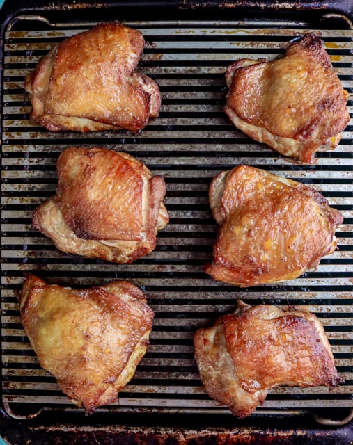 6 marinated chicken thighs cooked on a baking rack