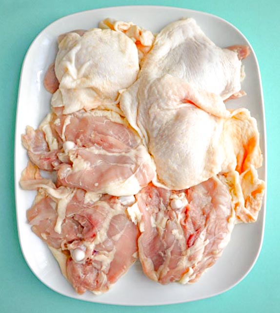 6 chicken thighs before they are trimmed of fat and excess skin