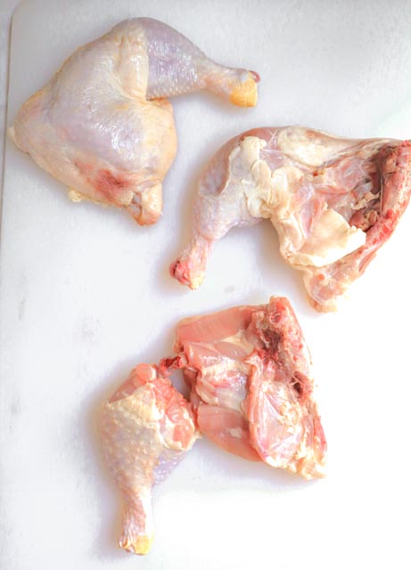 chicken legs showing inside of leg and outside also one cut into thigh and drumstick