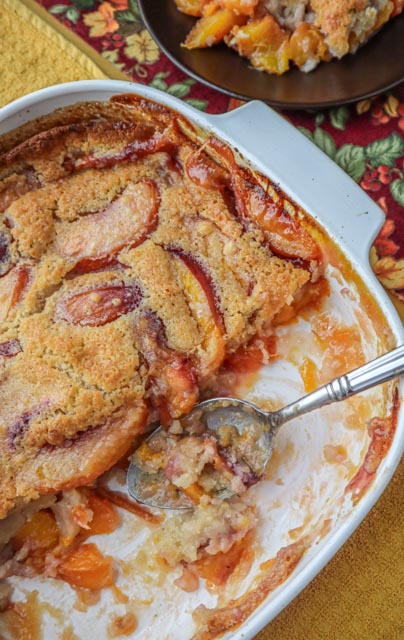 nectarine cobbler being served from a baking dish