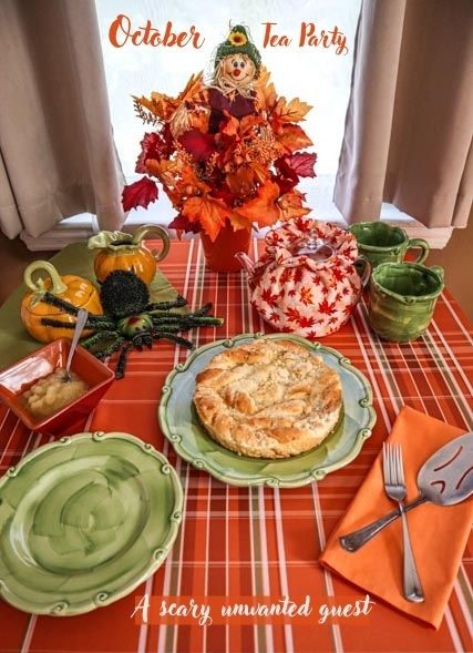 dinner table setting for october in orange and green with spider