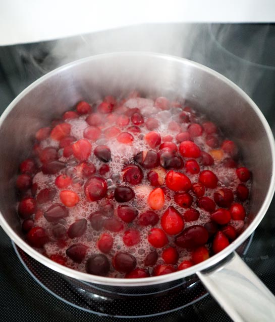 cranberries boiling in a saucepan