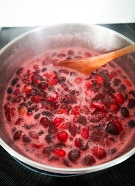 cranberries cooking in a saucepan